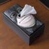 William Shakespeare tissue box holder with a tissue emerging from his nose.