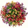 Artificial multicolor flower arrangement in a decorative pot on wooden table