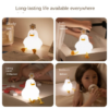 Cute duck night light glowing on table