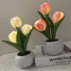 LED tulip flower lamp glowing in a white ceramic pot
